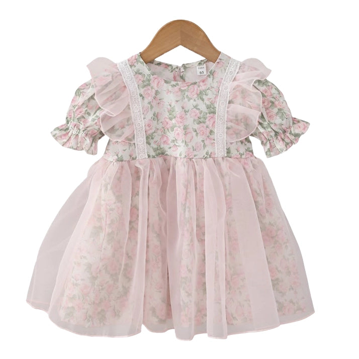 A toddler girl's short-sleeve dress with a pink and green floral print, featuring a lace-trimmed bodice, ruffled sleeves, and a layered tulle skirt, hanging on a wooden hanger against a white background.
