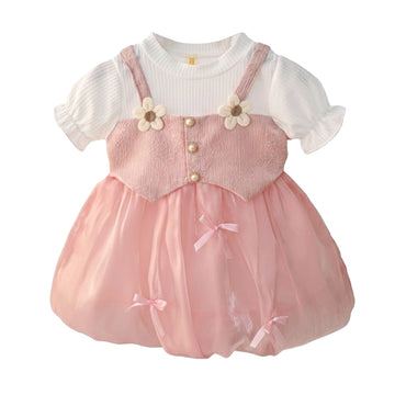 Girls pink pinafore party dress with white ribbed puff sleeve top, daisy flowers, pearl buttons and bubble skirt with bows – front view